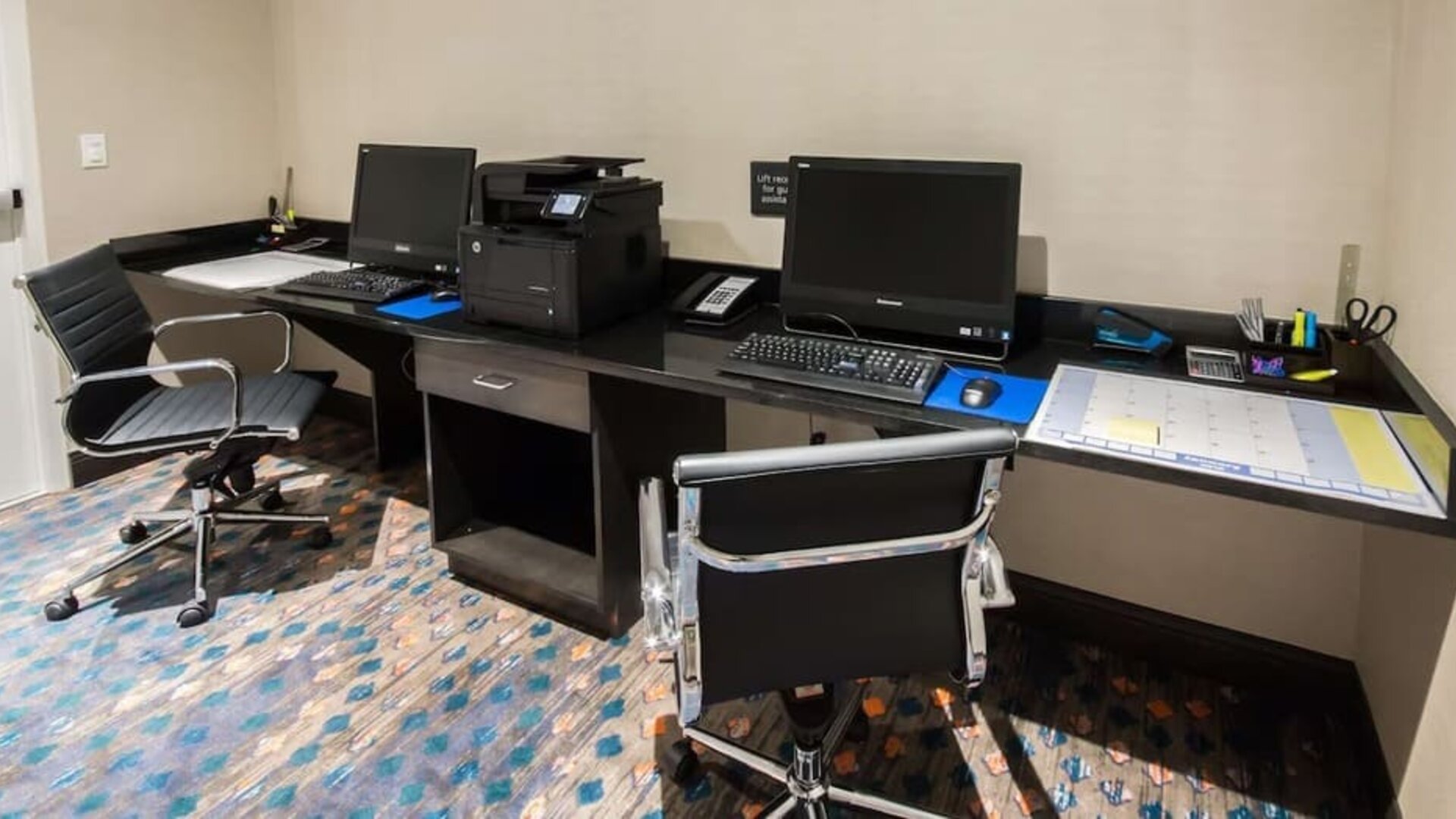 Business center with desktop computers, printer, and workstations at Hampton Inn & Suites Orlando at SeaWorld.
