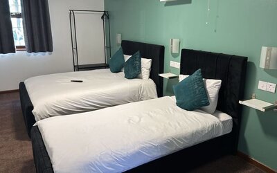 Guest room with two double beds and contemporary décor at Stay Inn Express.