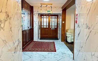Hotel lobby with marble-style flooring, elegant lighting, and comfortable seating at Stay Inn Express.