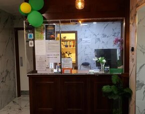 Reception desk with front desk services and guest check-in area at Stay Inn Express.