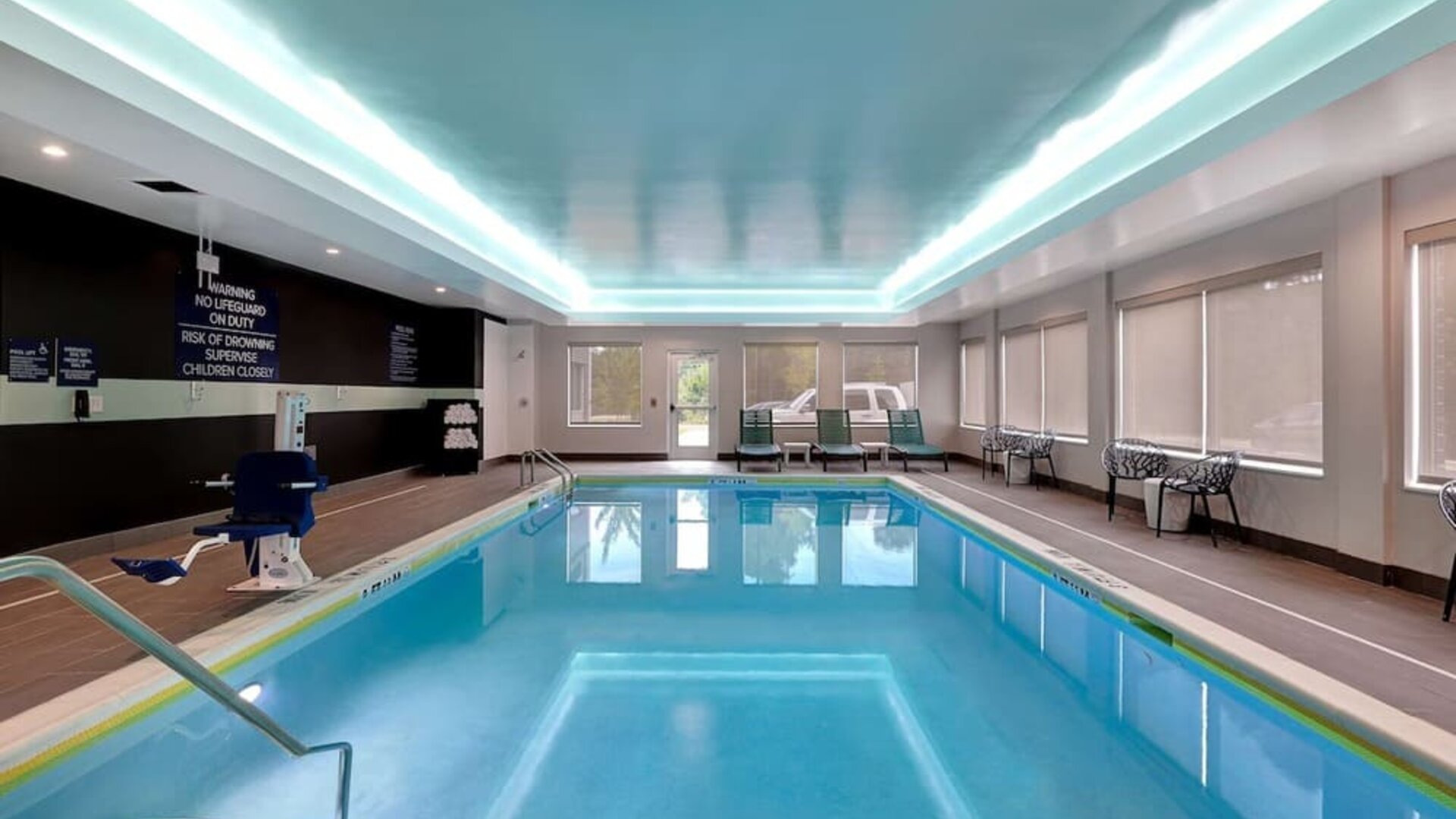 ndoor swimming pool with lounge seating and accessible amenities at Tru By Hilton Lithia Springs.