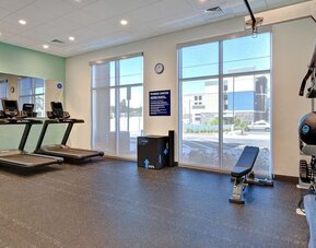 Fitness center with treadmills, free weights, and strength training equipment at Tru By Hilton Lithia Springs.