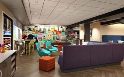 Vibrant hotel lobby with comfortable seating, games, and social gathering spaces at Tru By Hilton Lithia Springs.