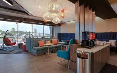 Lobby seating area with complimentary coffee station and contemporary furnishings at Tru By Hilton Lithia Springs.