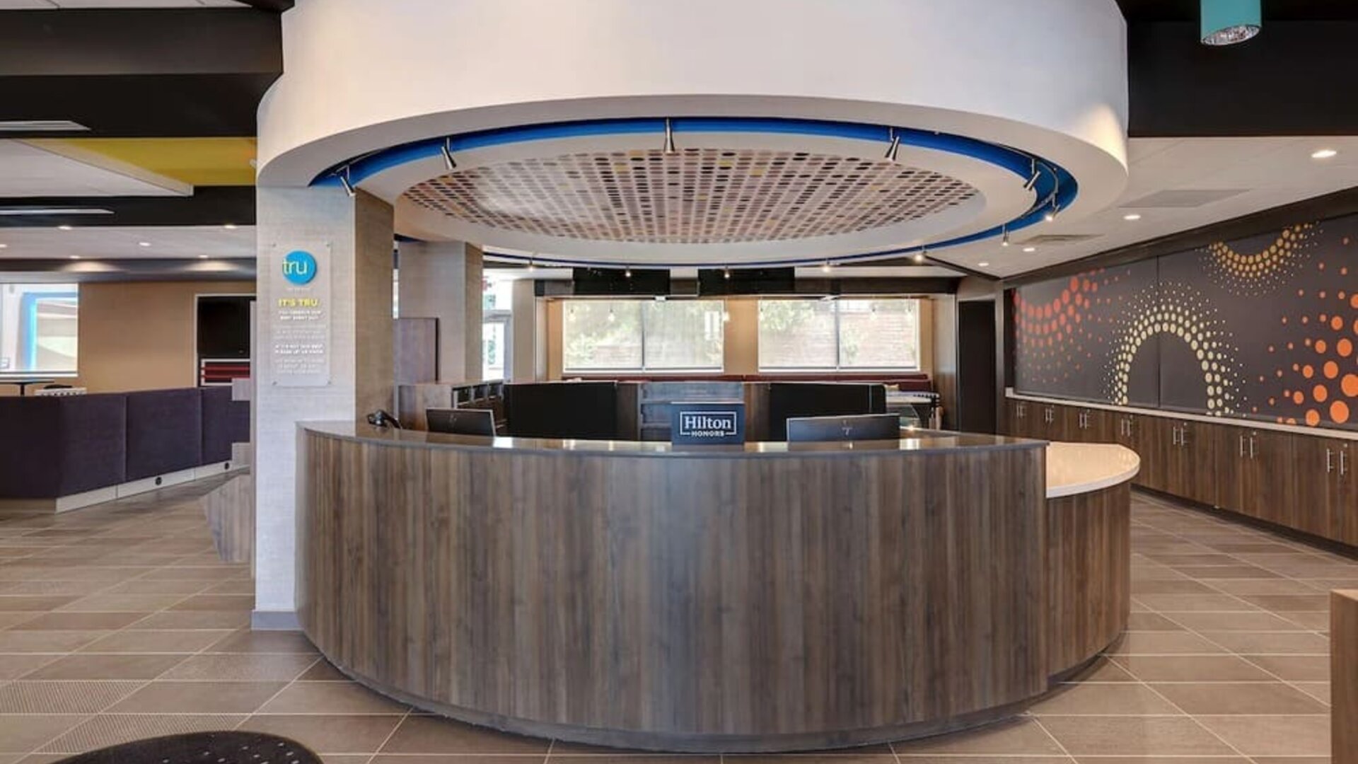 Contemporary reception desk with welcoming lobby and guest services at Tru By Hilton Lithia Springs.