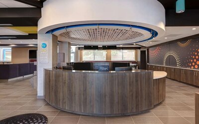 Contemporary reception desk with welcoming lobby and guest services at Tru By Hilton Lithia Springs.