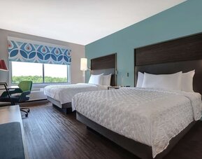 Guest room with two queen beds, workspace, and modern décor at Tru By Hilton Lithia Springs.