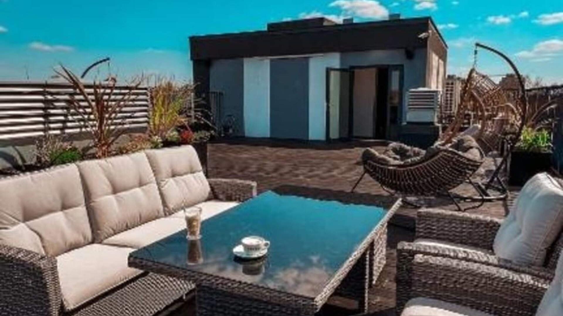Rooftop terrace with comfortable outdoor seating and city views at Hotel Seven.