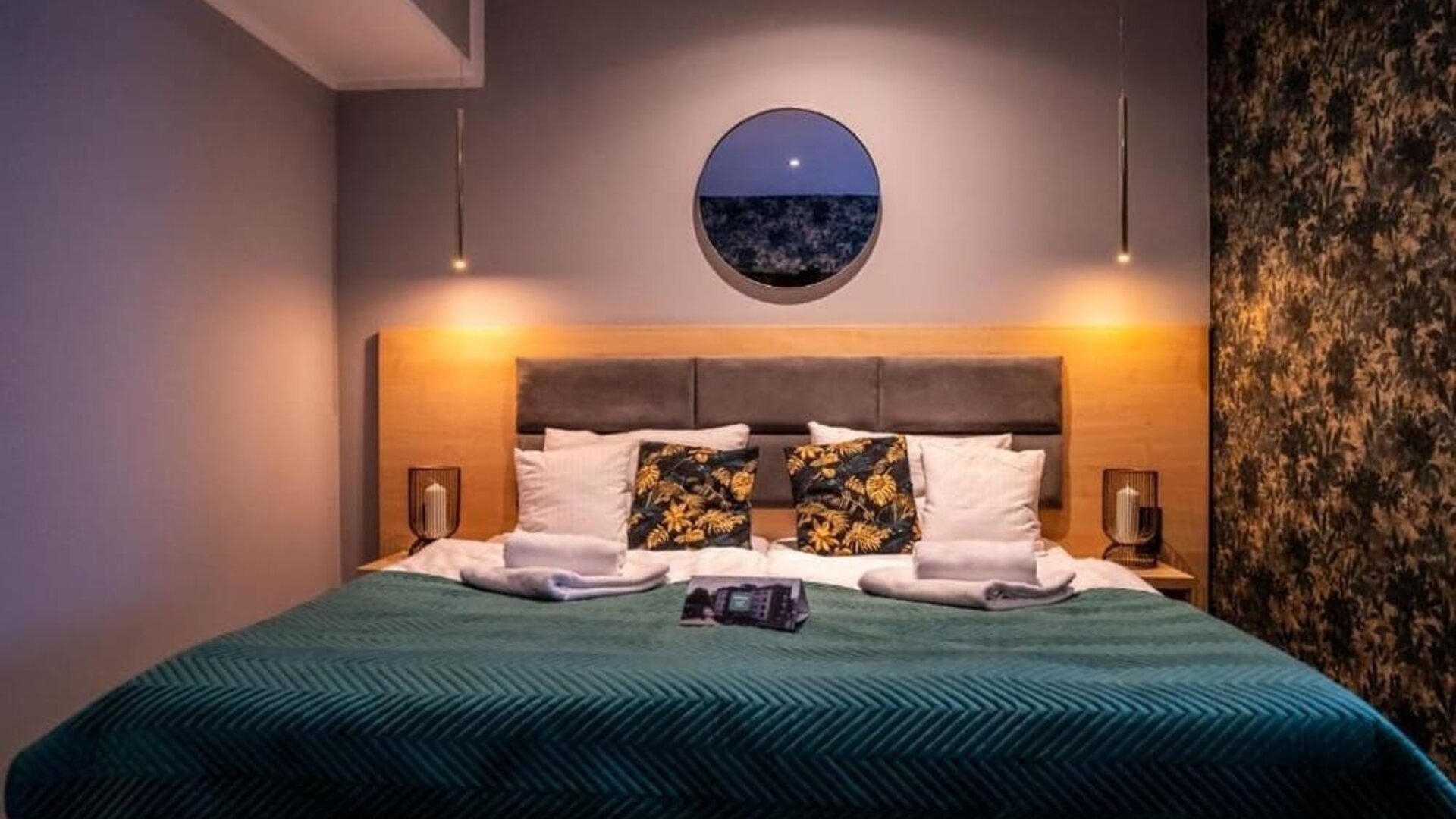 Contemporary king bedroom with feature lighting and modern furnishings at Hotel Seven.