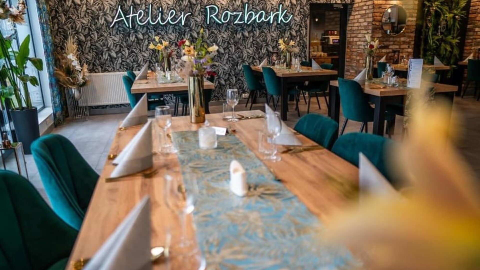 Contemporary dining area with botanical décor, wooden tables and stylish seating at Hotel Seven.