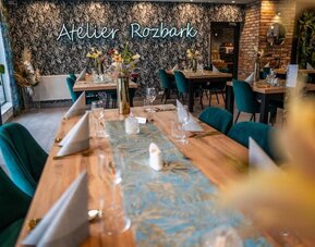 Contemporary dining area with botanical décor, wooden tables and stylish seating at Hotel Seven.