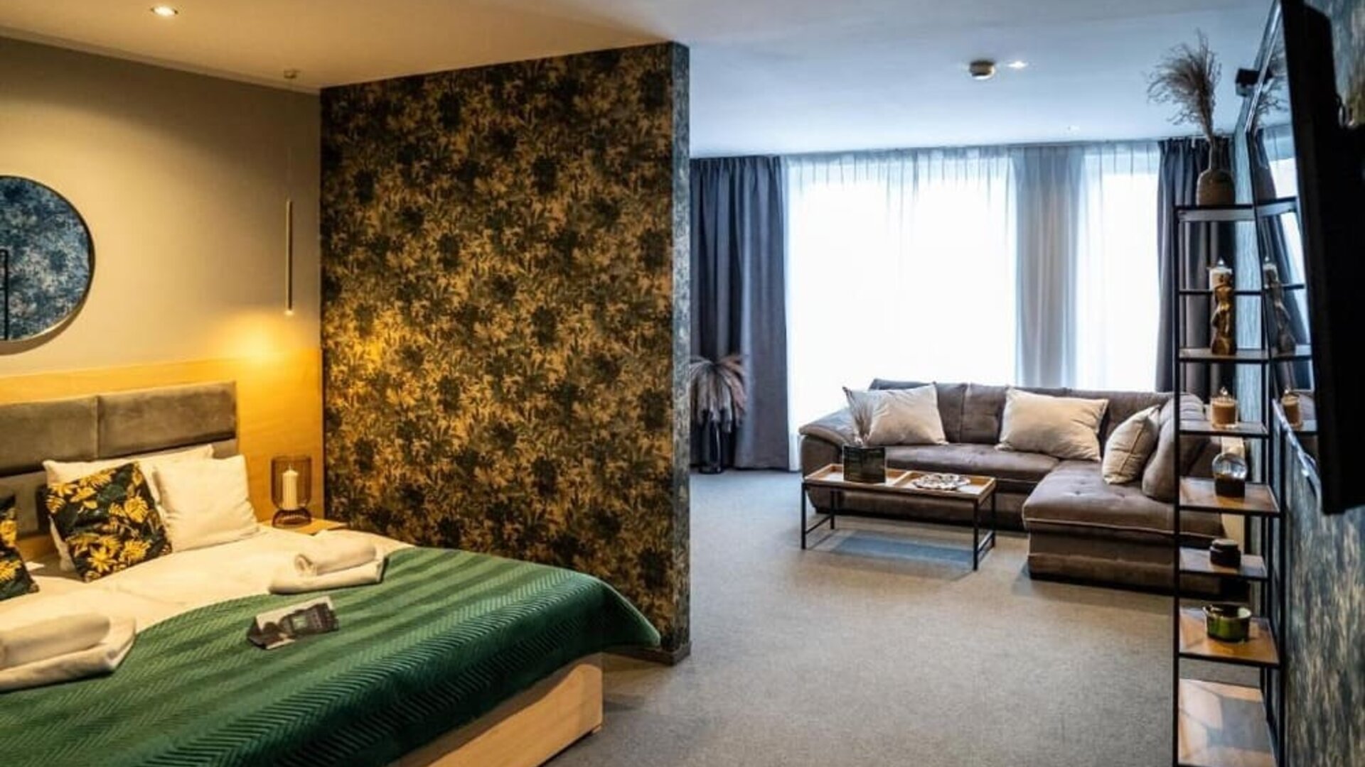 Spacious suite with king-size bed, separate living area and contemporary décor at Hotel Seven.