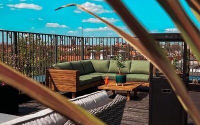 Modern rooftop lounge with outdoor furniture and open-air relaxation space at Hotel Seven.