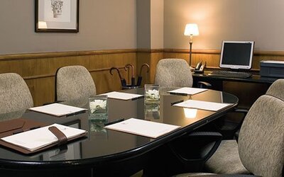 Private boardroom featuring executive seating, presentation facilities, and a professional setting for meetings and business discussions at Hotel Lafayette.