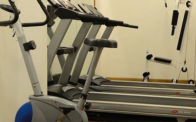 Fitness center equipped with treadmills, cardio machines, and strength-training equipment for guests maintaining their workout routines at Hotel Lafayette.