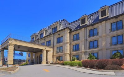 Exterior view of Hotel Brossard showcasing its elegant entrance and classic architecture.