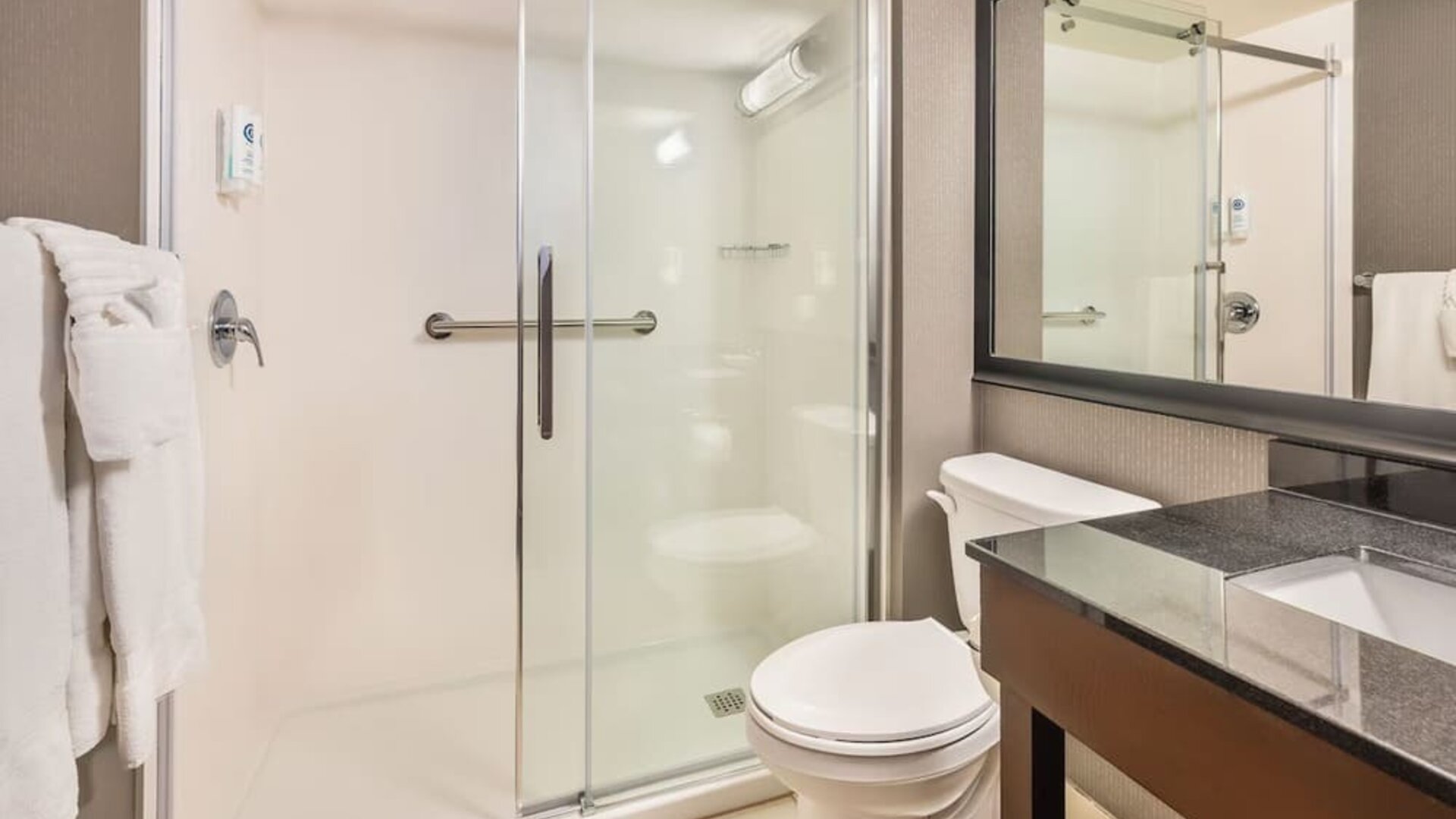 Modern guest bathroom with walk-in shower and contemporary vanity at Comfort Inn Laval.
