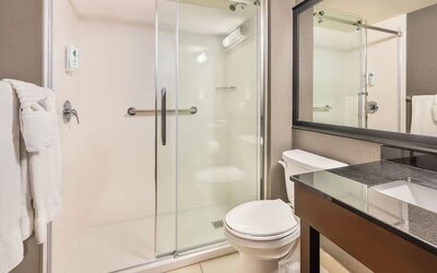 Modern guest bathroom with walk-in shower and contemporary vanity at Comfort Inn Laval.