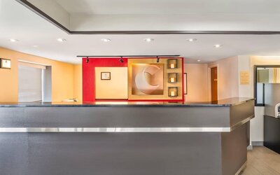 Modern hotel reception desk providing friendly guest services at Comfort Inn Laval.
