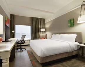 Contemporary king guest room with ergonomic workspace, comfortable seating and modern amenities at Hilton Garden Inn Calgary Downtown.