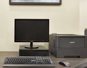 Business center with desktop computer, printer and workstation for guest use at Days Inn & Suites By Wyndham Lindsay.