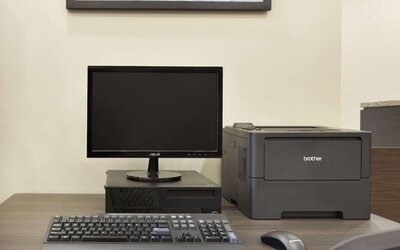 Business center with desktop computer, printer and workstation for guest use at Days Inn & Suites By Wyndham Lindsay.