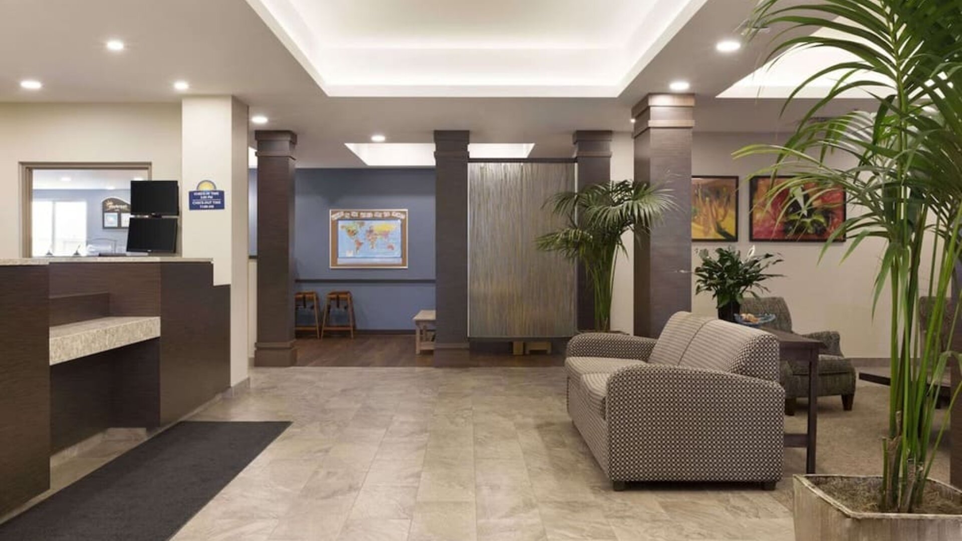 Bright hotel lobby with reception area, comfortable seating and contemporary décor at Days Inn & Suites By Wyndham Lindsay.