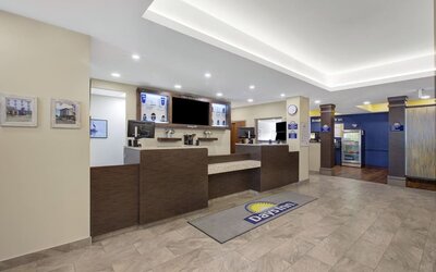 Modern reception area with front desk and welcoming lobby at Days Inn & Suites By Wyndham Lindsay.