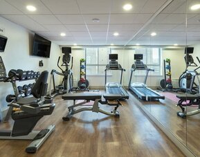Well-equipped fitness center with cardio machines, free weights and strength training equipment at Holiday Inn Express Toronto Downtown.