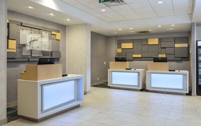 Modern reception area with front desk and welcoming check-in space at Holiday Inn Express Toronto Downtown.