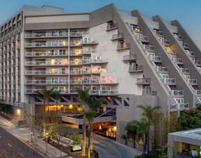 Evening exterior view of Hyatt Centric Delfina Santa Monica showcasing its modern design and convenient location near the beach and downtown attractions.