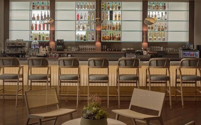 Modern hotel bar serving handcrafted cocktails, wine, beer, and light bites in a sophisticated lounge setting at Hyatt Centric Delfina Santa Monica.