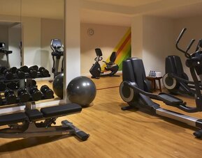Fully equipped fitness center featuring cardio machines, free weights, strength-training equipment, and exercise space at Hyatt Centric Delfina Santa Monica.