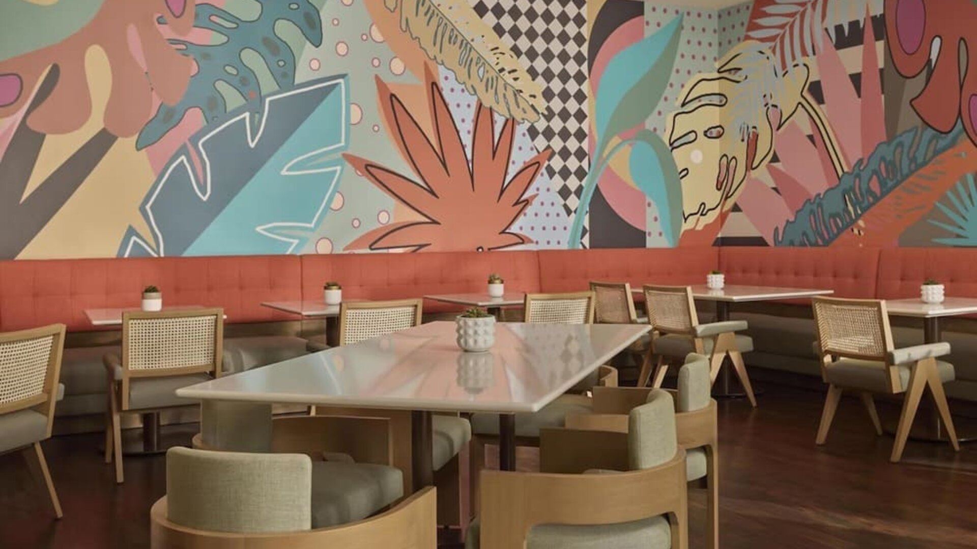 Contemporary hotel dining area with stylish seating, vibrant décor, and an inviting atmosphere for breakfast, lunch, and dinner at Hyatt Centric Delfina Santa Monica.