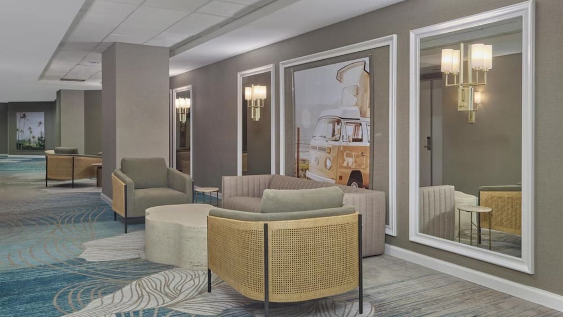 Comfortable lobby lounge with contemporary seating, modern artwork, and welcoming spaces to relax or socialize at Hyatt Centric Delfina Santa Monica.