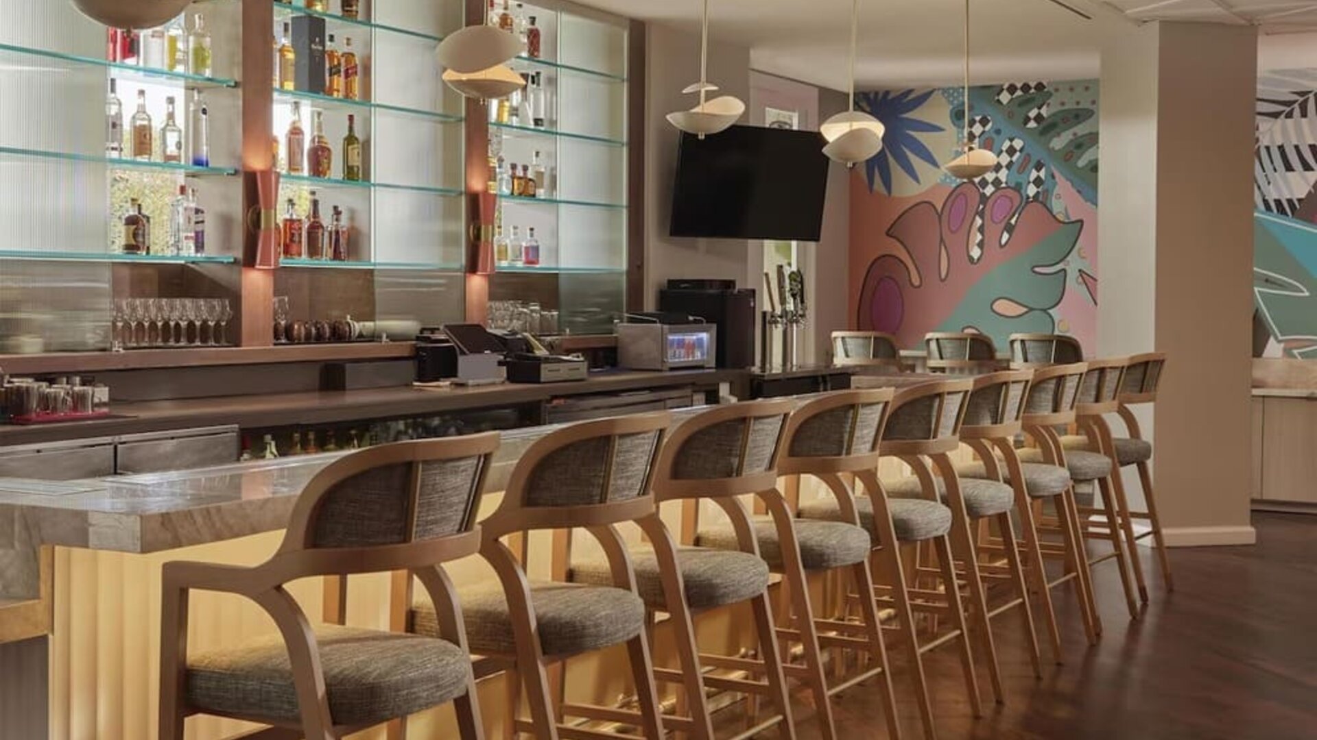 Contemporary hotel bar featuring handcrafted cocktails, premium spirits, and stylish seating in a vibrant social atmosphere at Hyatt Centric Delfina Santa Monica.