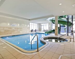 Indoor swimming pool with a hot tub and waterslide for family-friendly recreation at Fairfield Inn & Suites Guelph.