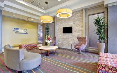 Stylish hotel lobby with comfortable seating, modern lighting, and a welcoming atmosphere at Fairfield Inn & Suites Guelph.