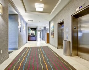 Modern hotel corridor with elevator access and contemporary interior design at Fairfield Inn & Suites Guelph.