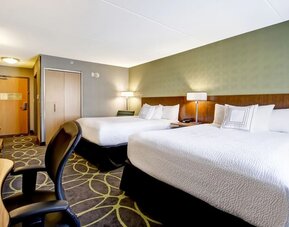 Spacious guest room with two queen beds, work desk, and contemporary furnishings at Fairfield Inn & Suites Guelph.
