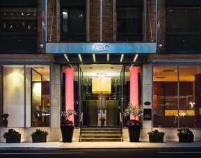 Elegant hotel entrance with contemporary architecture and a welcoming illuminated façade at ARC The Hotel Ottawa.