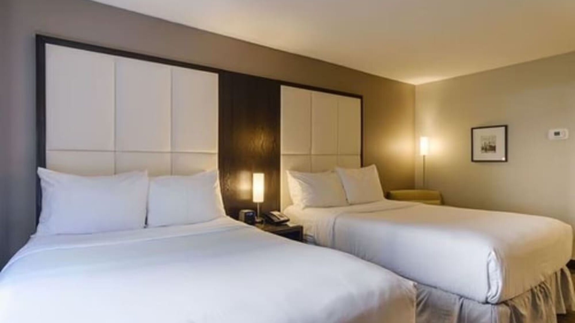 Comfortable guest room with two beds, premium bedding, and modern amenities for families or groups at ARC The Hotel Ottawa.