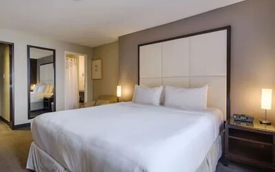 Day-use guest room featuring a comfortable king bed and modern amenities, ideal for work, relaxation, or a daytime stay at ARC The Hotel Ottawa.
