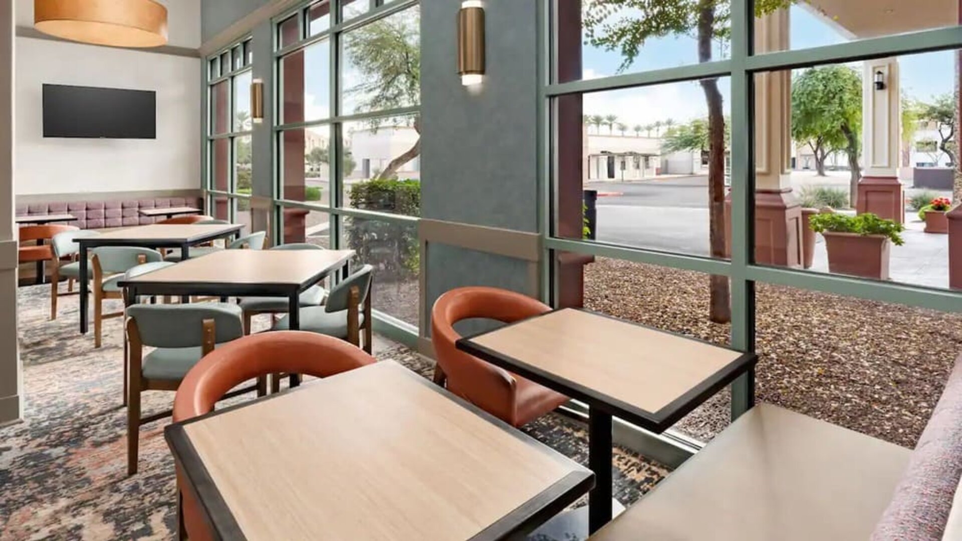Bright dining area with comfortable seating and floor-to-ceiling windows, perfect for breakfast, coffee, or casual meals at Hyatt Place Scottsdale/Old Town.