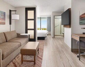 Spacious suite featuring a separate living area, sofa sleeper, dedicated workspace, and modern amenities at Hyatt Place Scottsdale/Old Town.