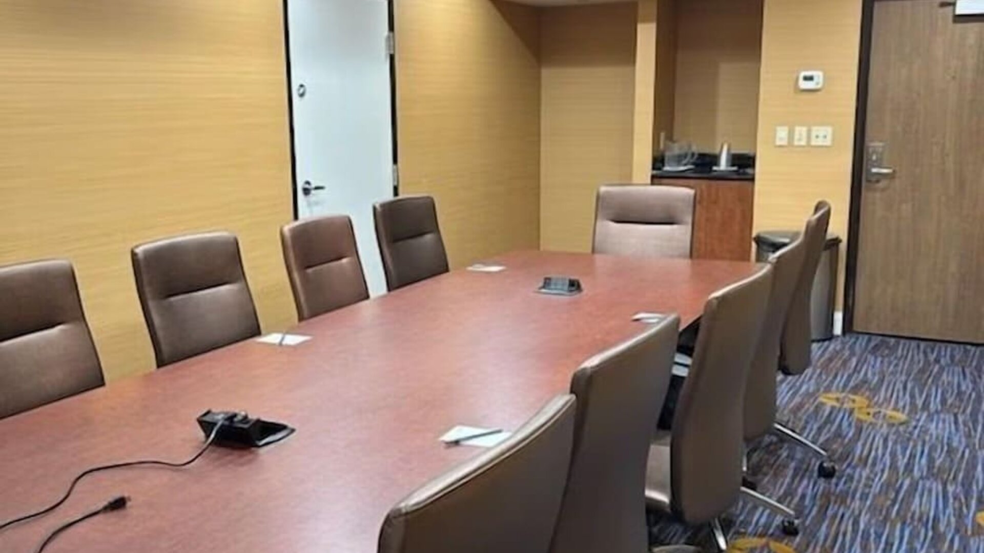 Private boardroom with conference table, ergonomic seating, and presentation connectivity for business meetings at Courtyard Riverside UCR/Moreno Valley Area.