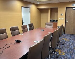 Private boardroom with conference table, ergonomic seating, and presentation connectivity for business meetings at Courtyard Riverside UCR/Moreno Valley Area.