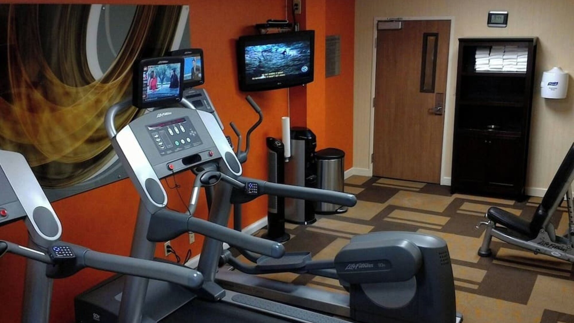 Fitness center featuring modern cardio machines, free weights, and workout equipment for guest use at Courtyard Riverside UCR/Moreno Valley Area.