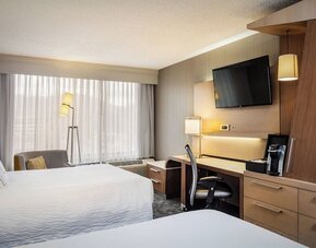 Guest room with two comfortable queen beds, spacious workstation, HDTV, and modern furnishings at Courtyard Riverside UCR/Moreno Valley Area.