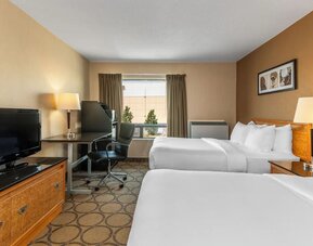Guest room with two double beds, a work desk, HDTV, and convenient in-room amenities at Comfort Inn Sherbrooke.